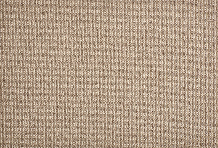 Close-up of Harper Berber Carpet in Buff—a beige, textured surface with subtle vertical stripes and a woven pattern. This soft, uniform carpet offers everyday durability and comfort, making it ideal for any space.