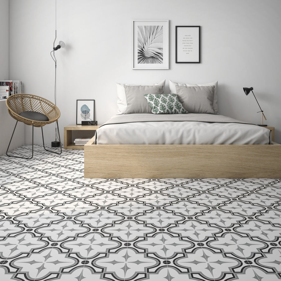 A European style bedroom featuring a bed, a chair, and Casablanca 8x8 Glazed Ceramic Patterned Tile with bold geometric designs.