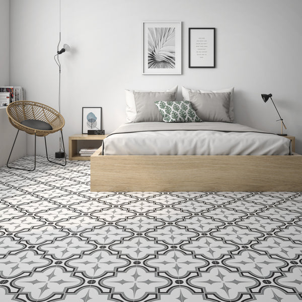 A European style bedroom featuring a bed, a chair, and Casablanca 8x8 Glazed Ceramic Patterned Tile with bold geometric designs.