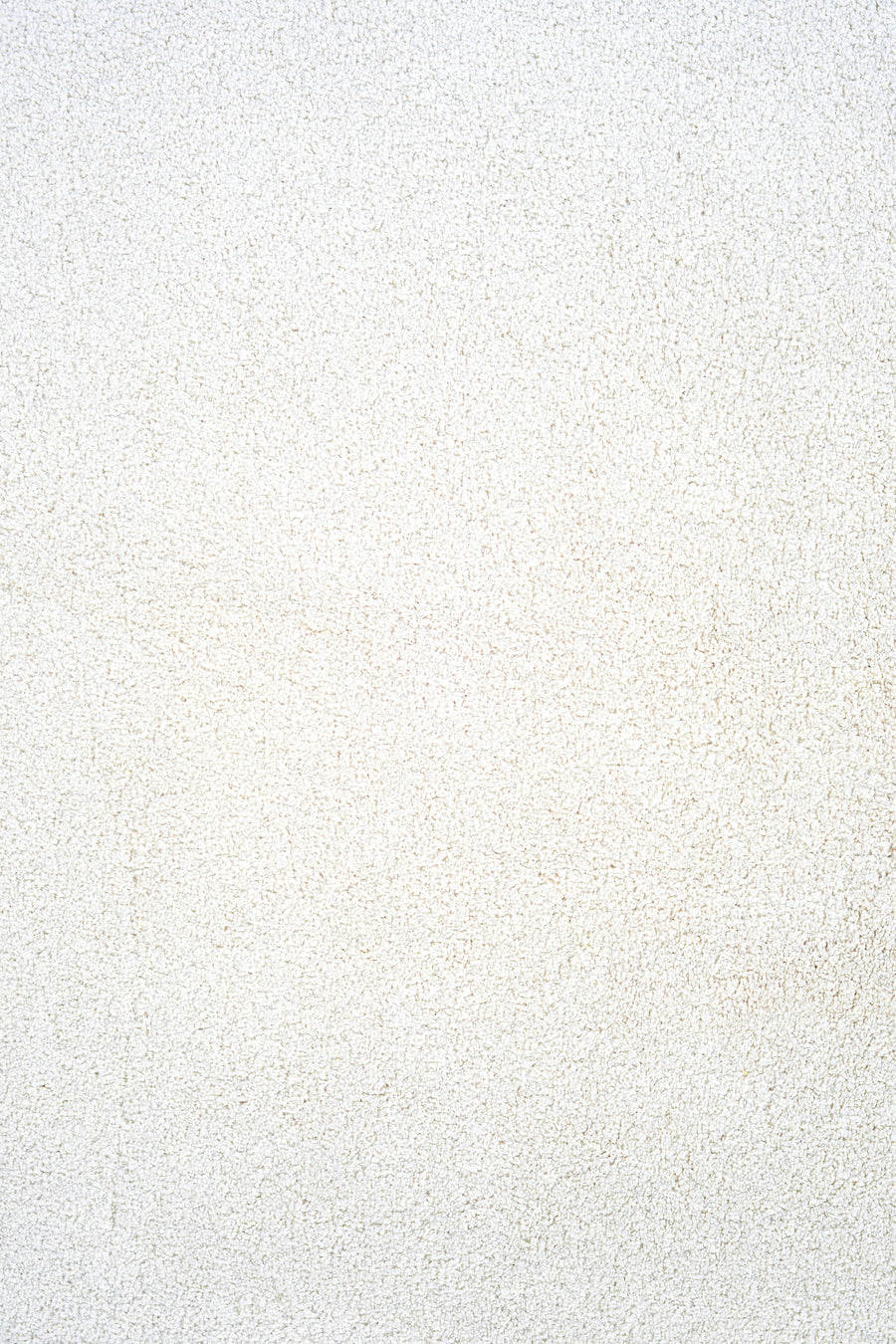 Close-up of Heavenly Family Friendly Carpet in Cotton color, showcasing its textured, grainy surface with subtle color variations that evoke the look and feel of a luxury carpet.