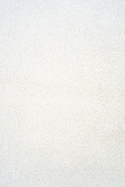 Close-up of Heavenly Family Friendly Carpet in Cotton color, showcasing its textured, grainy surface with subtle color variations that evoke the look and feel of a luxury carpet.