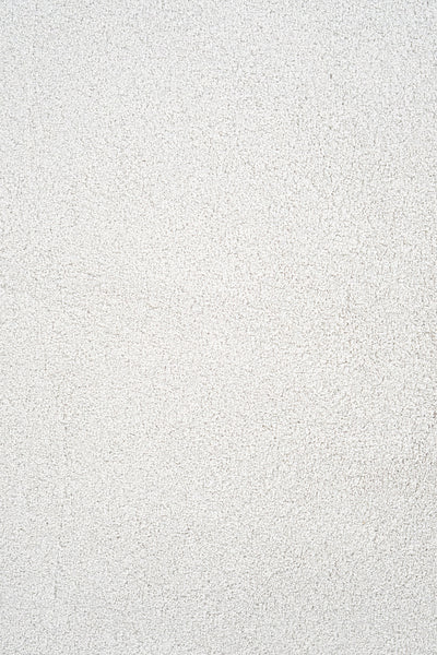 A close-up of the Heavenly Family Friendly Carpet in Sea Salt showcases its white, textured surface with subtle shading variations, offering a sophisticated and refined look reminiscent of luxury for any space.