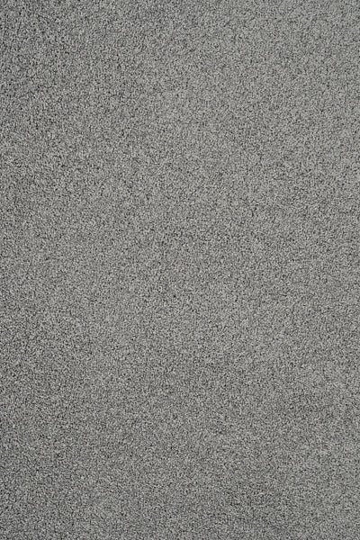 Close-up of Heavenly Family Friendly Carpet in Flint—textured, gray, and uniform with a fine, granular look. Perfect inspiration for luxury flooring that’s stain resistant and ideal for family spaces.