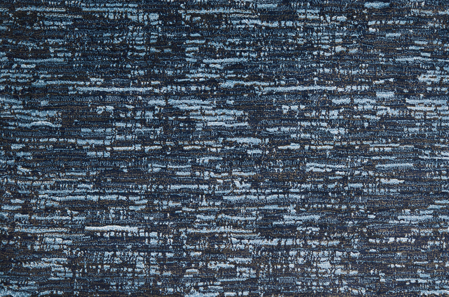 A close-up of Olde Chatham On Trend Carpet in Navy shows a textured, abstract pattern of blue and black streaks with a woven look—perfect for high-traffic areas.