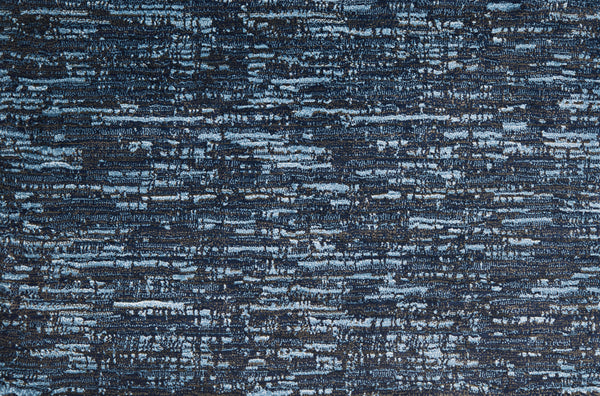 A close-up of Olde Chatham On Trend Carpet in Navy shows a textured, abstract pattern of blue and black streaks with a woven look—perfect for high-traffic areas.