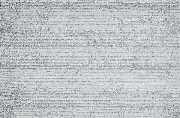A close-up of a textured gray surface with wavy lines, similar to the refined Platinum color and pattern of Olde Chatham On Trend Carpet, celebrated for its luxury look and durable construction.