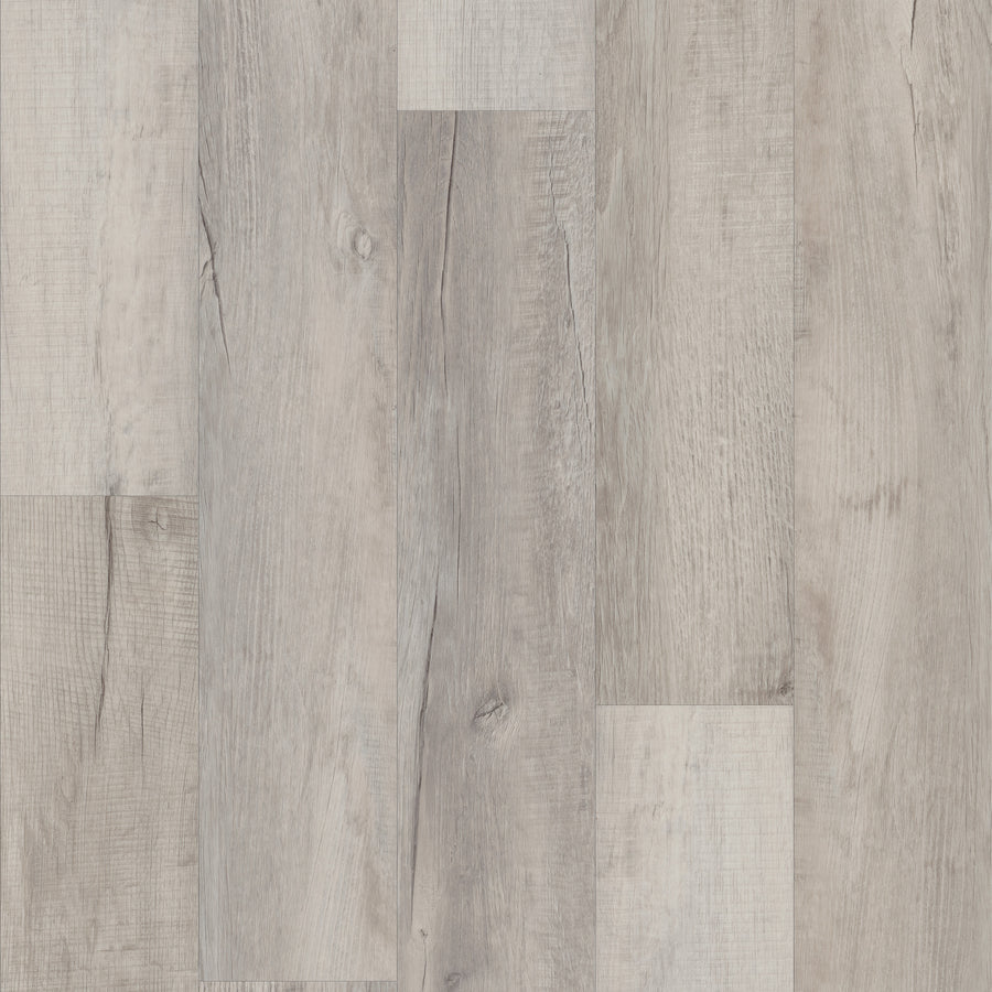 A close-up view of Coretec Pro Plus Vinyl flooring planks in light gray and beige tones, showing natural grain and texture. The rigid core planks are installed side by side in a staggered pattern.