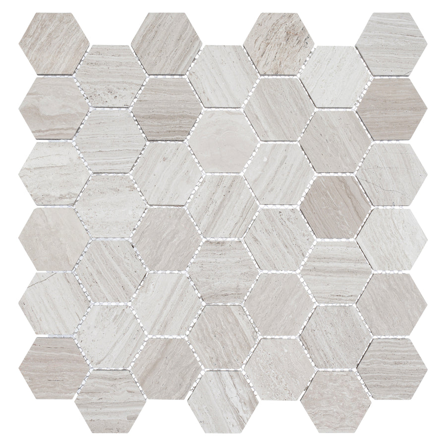 The Colonial 2" Hexagon Ceramic Tile in Virginia Dunes features a grid of hexagonal tiles with natural stone textures in beige and light gray, highlighted by subtle striations and a smooth, polished ceramic finish.
