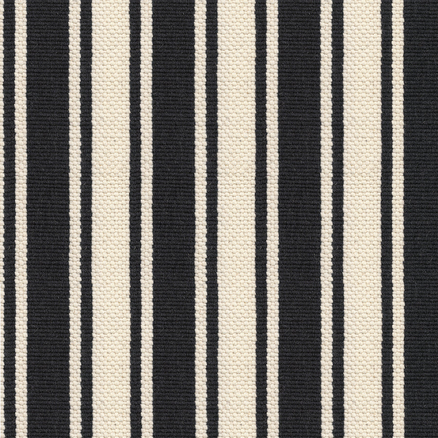 A close-up of Cabana On Trend Carpet shows vertical black and cream stripes in varying widths with a textured, woven look, making it a stylish choice.