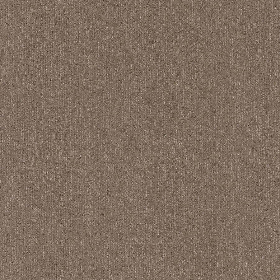Close-up of Sneak Peak Berber Carpet in Caffeine color, showing a consistent brown textured surface with a subtle vertical ribbed pattern that highlights its dense pile and durability as flooring.