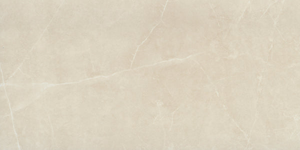 The Callie 12x24 Matte Porcelain Tile in Alabaster features a light beige surface with subtle white veining, offering a smooth, elegant look ideal for sophisticated floors or countertops.