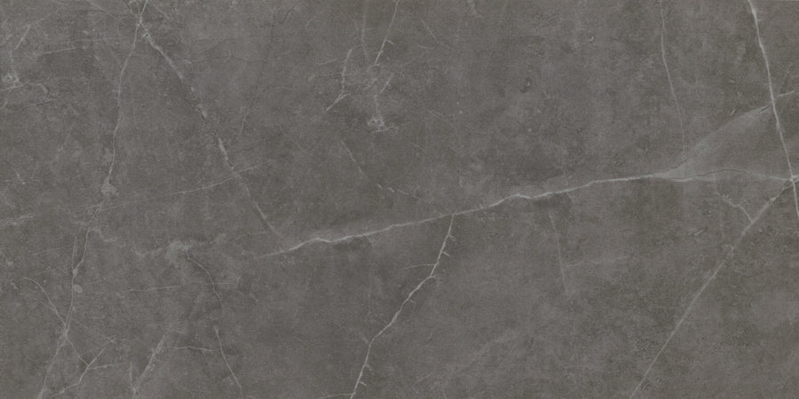 Callie 12x24 Polished Porcelain Tile in Smoke features a dark gray marble-look surface with delicate white veining, natural stone texture, and elegant irregular patterns for a sophisticated finish.