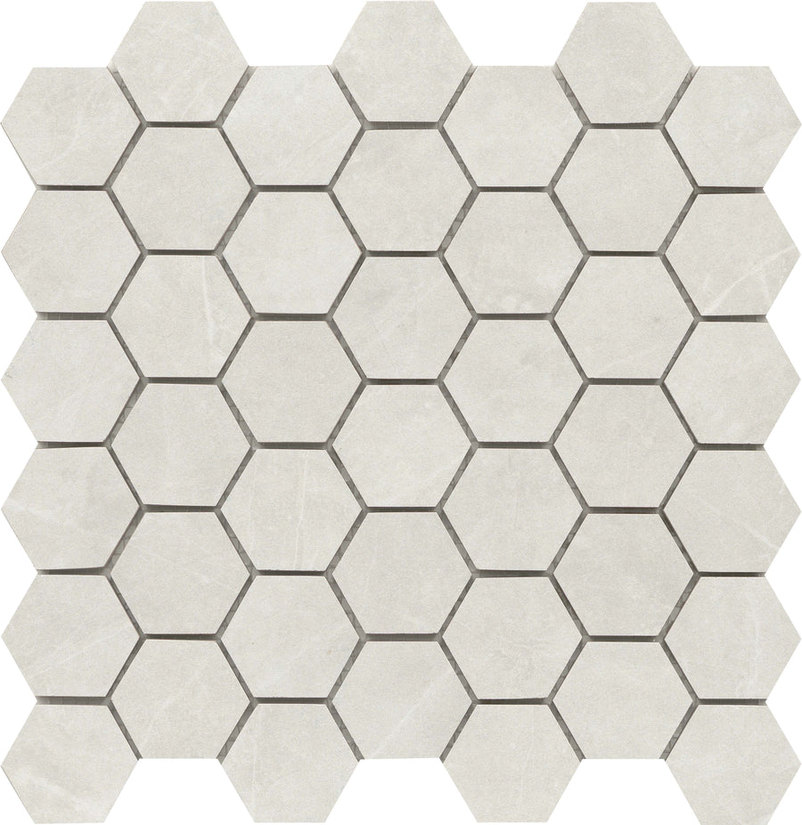 The Callie 2" Hexagon Porcelain Mosaic in Steel features a grid of light gray hexagonal tiles with stone-like textures. Dark grout lines contrast with the porcelain, adding an upscale touch to this elegant mosaic design.