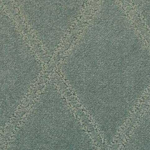 Close-up of the Braided Opulence Berber Carpet in Cambridge color, showing its textured green surface with a subtle diamond pattern formed by raised, stitched diagonal lines.