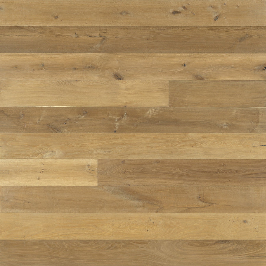 The Provincetown 7 1/2" White Oak Hardwood features wide, horizontal planks in light brown tones that showcase natural grain and knots for a rustic, welcoming look.