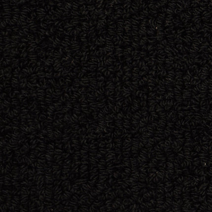 Close-up of Savant Berber Carpet in Carroll color, showing its tightly looped fibers and dense, textured black surface—providing durable flooring perfect for high-traffic areas.