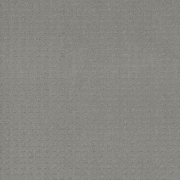 A close-up of Caspian Berber Carpet in Icefield shows its gray textured surface with a fine square grid pattern, crafted from premium fibers for enhanced durability.