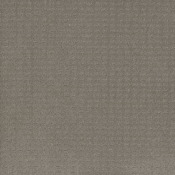Close-up of Caspian Berber Carpet in Stratosphere, featuring a textured gray surface with a subtle grid-like waffle pattern. Crafted from premium fibers for a raised, tactile appearance that evokes classic Berber sophistication.