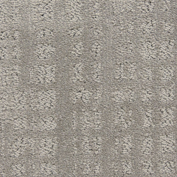Close-up of the Willow Lake On Trend Carpet in Castle Rock—a textured gray luxury carpet featuring a subtle, raised geometric pattern of small squares and rectangles. Ideal for high-traffic areas, it delivers a soft yet structured look.