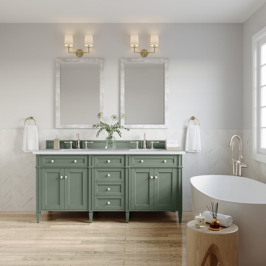 A modern bathroom features the Brittany 72" Double Bowl Vanity in sage green, two mirrors, wall lights, white towels, a freestanding tub, wooden stool, window with natural light, plus plants and simple decor accessories.