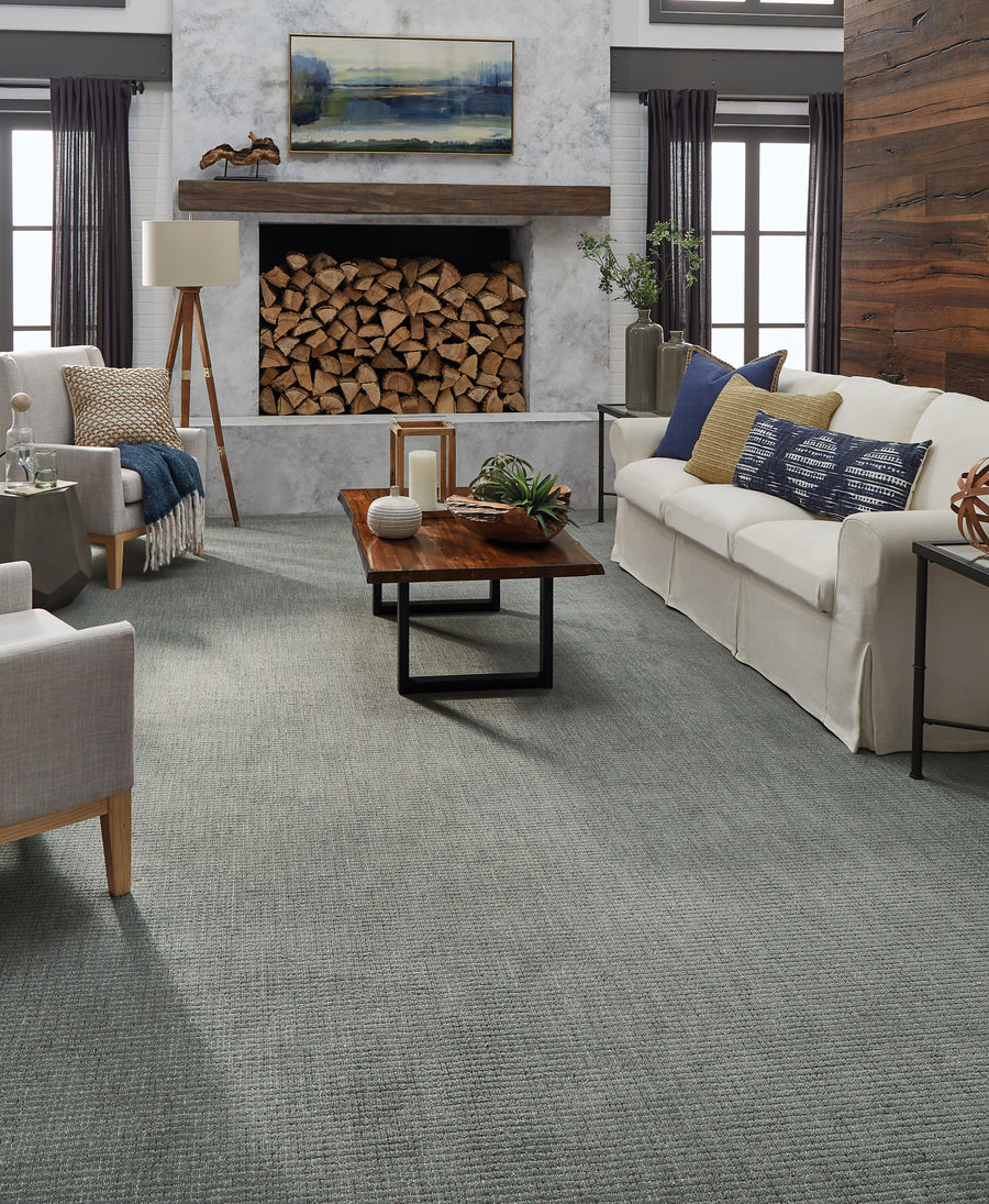 A living room with a fireplace and couches.