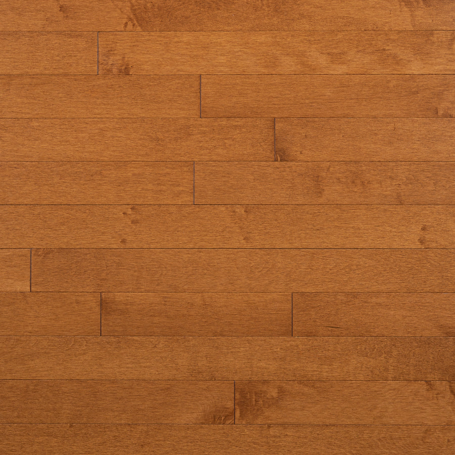Champlain Maple ¾" x 3 1/4" Hardwood features a light brown, dent-resistant surface with a smooth texture and natural grain. Horizontal planks in a staggered pattern create an elegant silver maple look throughout any space.