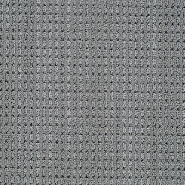 Close-up of Top Notch Berber Carpet in Charcoal, featuring a grid-like woven texture with small raised squares and darker lines. This stylish, stain-resistant material offers a subtle geometric look reminiscent of classic Berber designs.