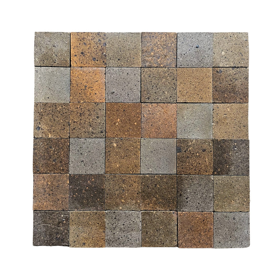 A square layout of 25 Atelier Clay 2x2 Mosaic Natural Stone tiles in brown, gray, and beige shades creates a simple mosaic pattern on a white background.