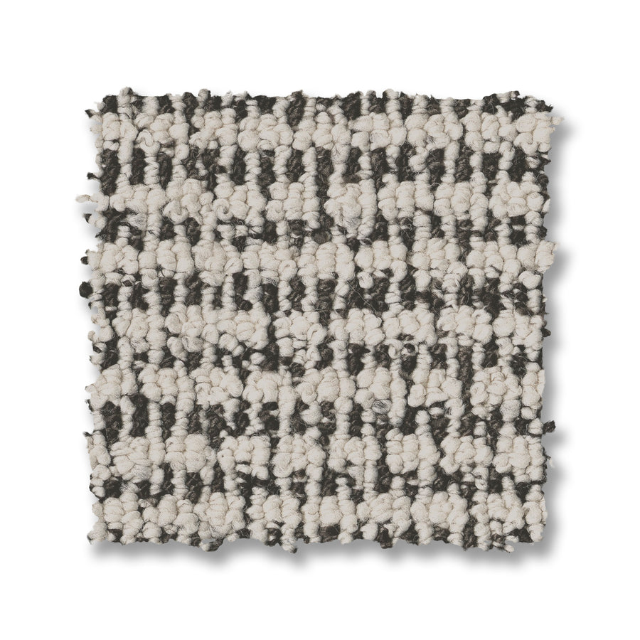 A square sample of Laine On Trend Carpet with a looped texture and black-and-white checkered pattern is shown on a white background, showcasing the carpet’s premium style.