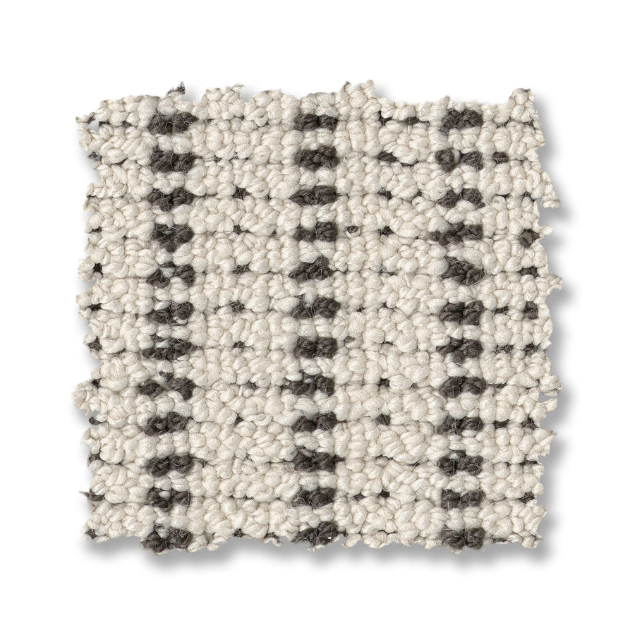 The Laken On Trend Carpet features a textured, woven cream base with dark gray vertical stripes. Slightly frayed edges showcase its thick, looped construction, resembling a luxury carpet swatch.