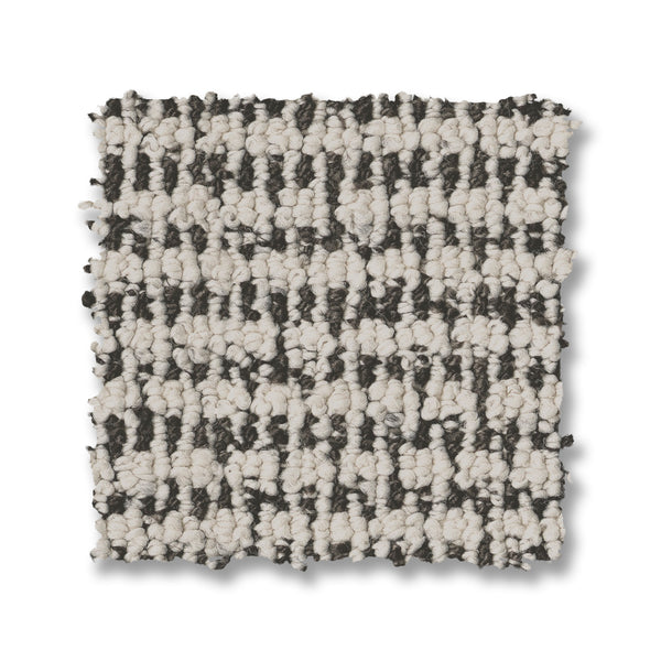 A square sample of Laine On Trend Carpet with a looped texture and black-and-white checkered pattern is shown on a white background, showcasing the carpet’s premium style.