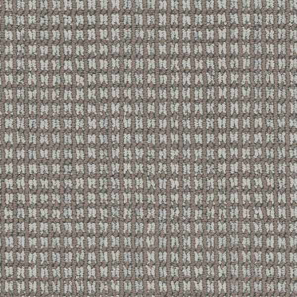 Close-up of Haven Berber Carpet in Chinchilla color shows a soft, durable surface with a textured grid pattern. Brown and white threads create a checkered, waffle-like look reminiscent of classic Berber design.
