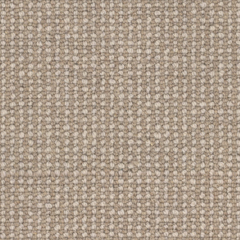 Close-up of the Andros Berber Carpet in Chora, showcasing its beige woven fabric with a textured, grid-like pattern created by intersecting threads, reminiscent of classic premium Berber design.