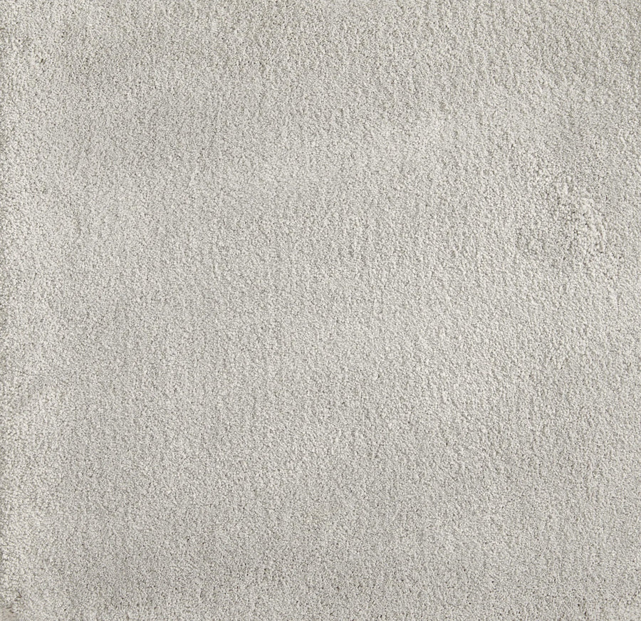 Close-up view of Cha Cha On Trend Carpet in Cirrus—a light gray, soft, textured flooring with a uniform look. Durable and ideal for high-traffic areas in contemporary spaces.