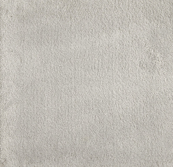 Close-up view of Cha Cha On Trend Carpet in Cirrus—a light gray, soft, textured flooring with a uniform look. Durable and ideal for high-traffic areas in contemporary spaces.