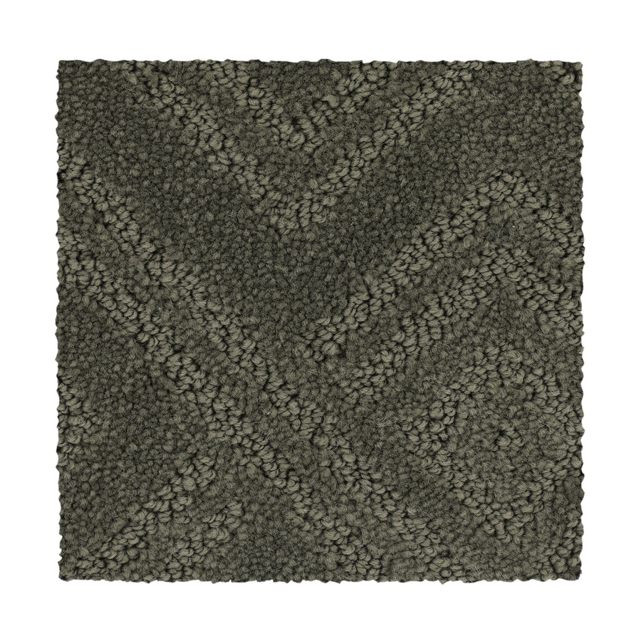 Classic Frame Family Friendly Carpet in Highlander offers a durable, dark gray textured surface with a raised chevron zigzag pattern of tightly looped, variably sized fibers for added depth and dimension.