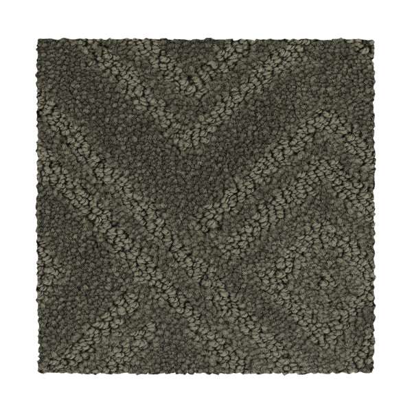 Classic Frame Family Friendly Carpet in Highlander offers a durable, dark gray textured surface with a raised chevron zigzag pattern of tightly looped, variably sized fibers for added depth and dimension.