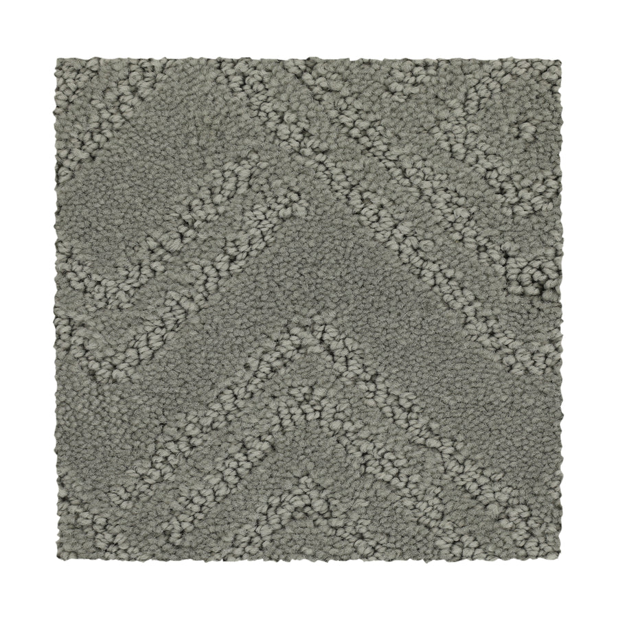 A rectangular swatch of Classic Frame Family Friendly Carpet in Steambath, showcasing a gray, durable chevron pattern with alternating rows of tightly and loosely woven fibers.