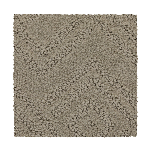 A rectangular swatch of Classic Frame Family Friendly Carpet in Sand Dollar, featuring a textured, raised chevron pattern on a white background.