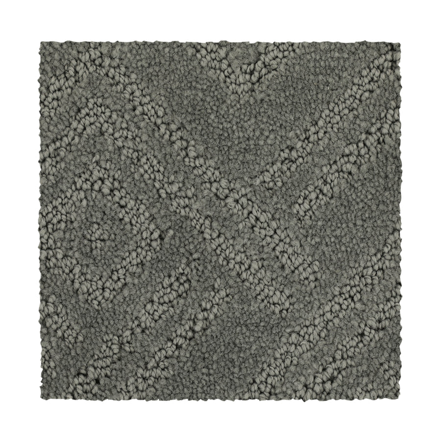 The Classic Frame Family Friendly Carpet in pewter features a rectangular shape with a textured surface and raised diamond and diagonal line pattern, shown against a white background.