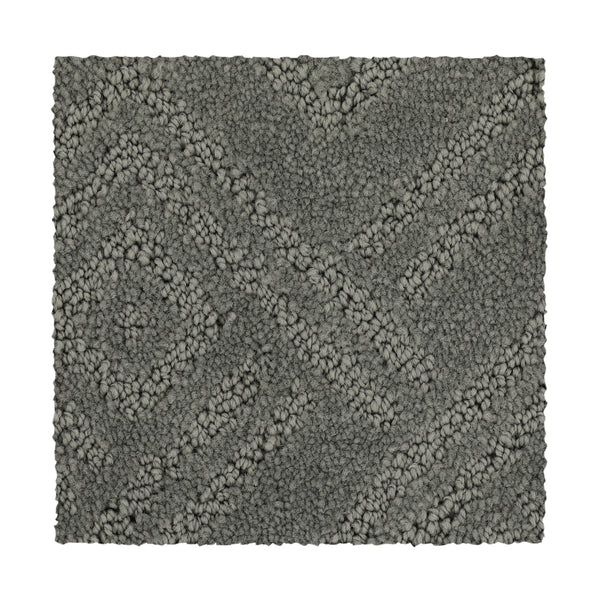 The Classic Frame Family Friendly Carpet in pewter features a rectangular shape with a textured surface and raised diamond and diagonal line pattern, shown against a white background.