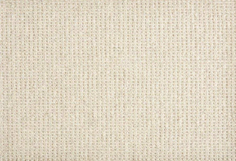 Close-up of Martina Berber Carpet in Cloud, featuring a beige woven fabric with a subtle grid pattern and slightly rough texture. Its tight weave adds contemporary style, making it ideal as a simple, neutral background for high-traffic areas.
