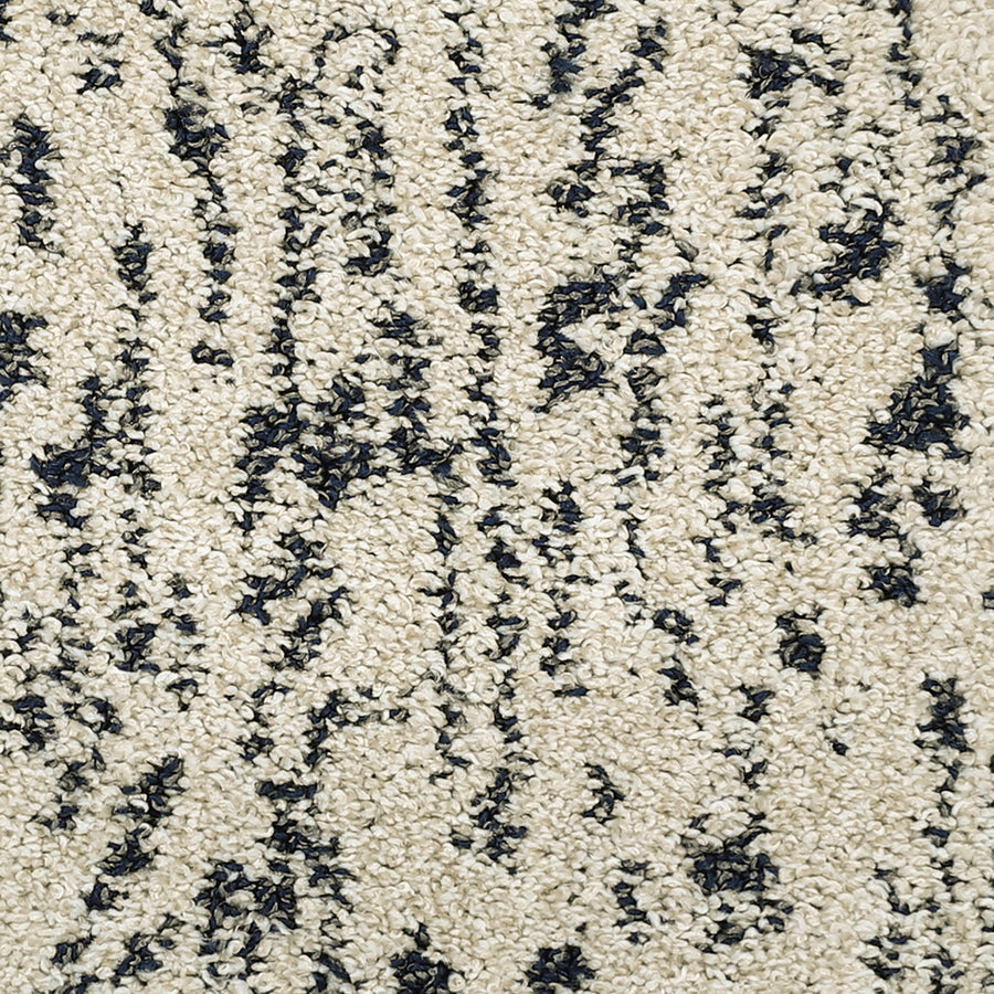 Close-up of the Meow Mosaic Pet Friendly Carpet, showing its textured beige surface with irregular black speckled patterns.