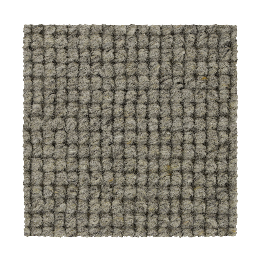 A square sample of Collanmore Berber Carpet in Coastal Mist, featuring a textured gray looped grid pattern—crafted from thick yarns in parallel rows, ideal as premium flooring for high-traffic areas.