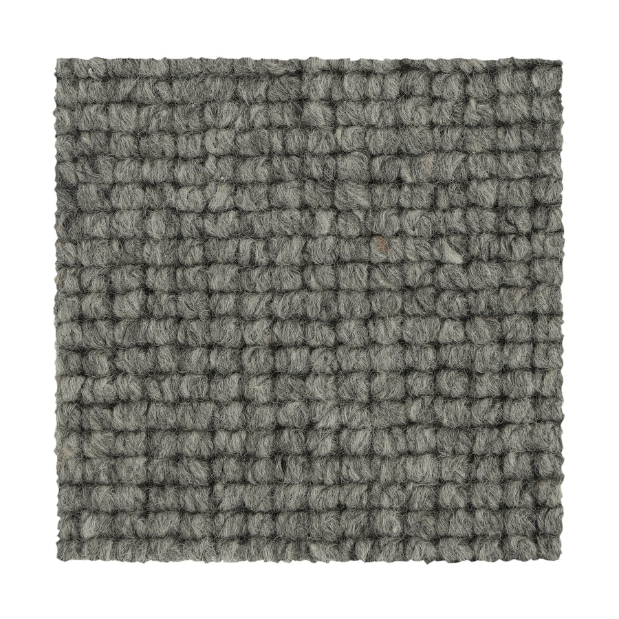 Square swatch of Collanmore Berber Carpet in Moonstone, showing a textured looped gray surface with a grid-like woven pattern and chunky yarn fibers. Perfect for high-traffic areas, sample is displayed on a white background.
