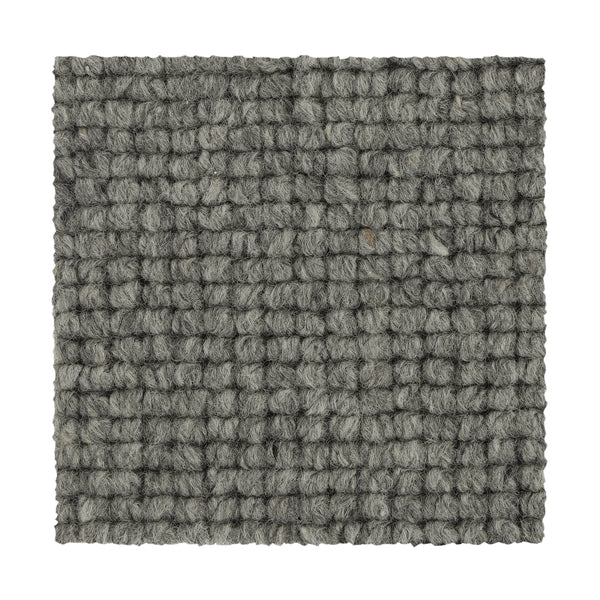 Square swatch of Collanmore Berber Carpet in Moonstone, showing a textured looped gray surface with a grid-like woven pattern and chunky yarn fibers. Perfect for high-traffic areas, sample is displayed on a white background.