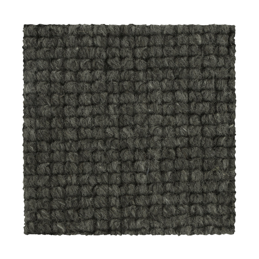 A square swatch of Collanmore Berber Carpet in Aspen Summit, featuring a dark grey looped pile and textured pattern, ideal for high-traffic areas and shown against a white background.