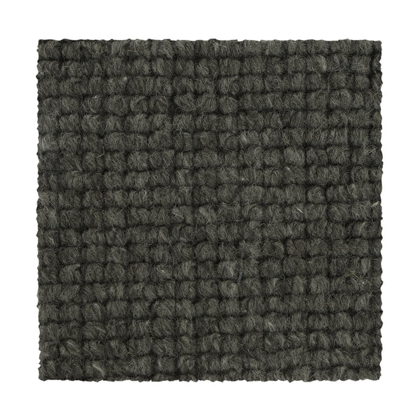 A square swatch of Collanmore Berber Carpet in Aspen Summit, featuring a dark grey looped pile and textured pattern, ideal for high-traffic areas and shown against a white background.