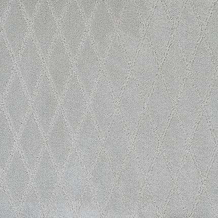 Absolute Berber Carpet in Concrete features a light gray hue with a subtle raised diamond pattern for a soft, quilted effect. This durable carpet offers a gentle geometric look, making it ideal for high-traffic areas.