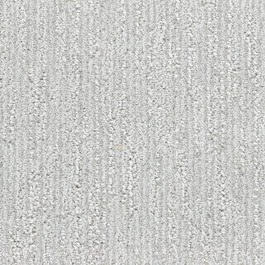 Close-up of Contentment Pet Friendly Carpet in light gray, showing a soft, looped fiber surface with a subtle vertical line pattern that's also stain-resistant.